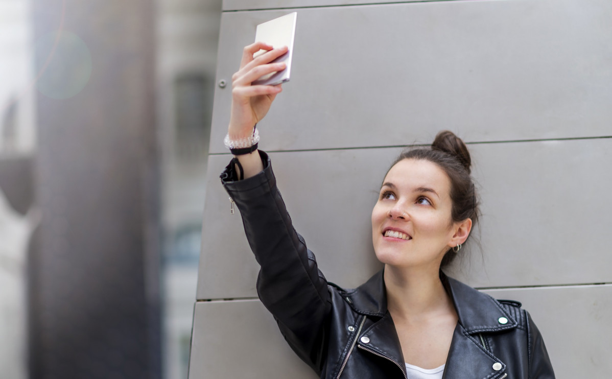 Smiling woman taking selfie near column 2023 11 27 05 26 25 utc