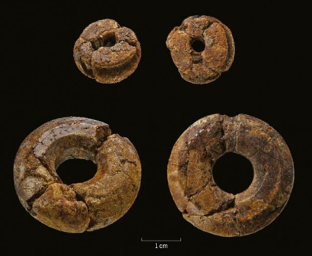 Las dos cuentas de ámbar fueron excavadas en un depósito de cimentación bajo el gran zigurat de Assur, Irak.