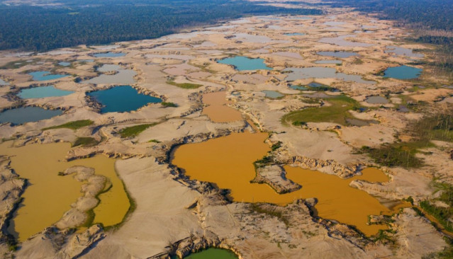 Estanques mineros poco profundos abruman un antiguo sistema fluvial en la región de La Pampa en Madre de Dios, Perú.