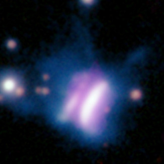Esta imagen compuesta de radio y óptica proporcionada por investigadores en mayo de 2024 muestra IRAS 23077, en el centro, un disco de formación de planetas y varias estrellas circundantes.