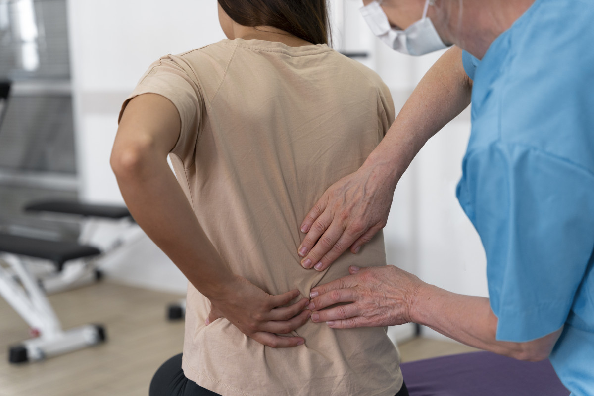 Medical assistant helping patient with physiotherapy exercises