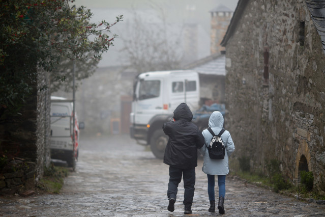Archivo - Dos personas abrigadas en una calle del municipio de Pedrafita do Cebreiro, 13 de diciembre de 2023, en Pedrafita do Cebreiro, Lugo, Galicia (España). Un nuevo frente de frío ha entrado hoy por las montañas del este gallego, que dejará temperatu