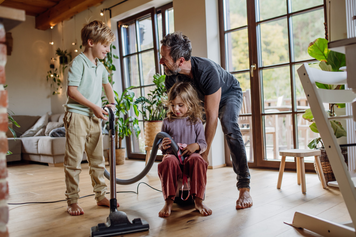 Father and kids cleaning house vacuuming the floo 2024 10 18 10 07 20 utc