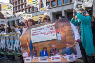 Manifestantes portan pancarta con lema 'La firma de la vergüenza' durante la manifestación contra el Estatuto Marco del Ministerio de Sanidad, a 14 de febrero de 2026, en Madrid (España). La Confed