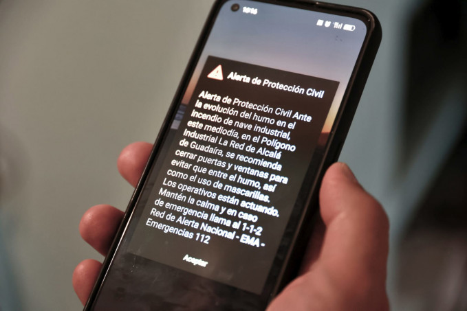 Archivo - Alerta de protección civil recibida en un móvil por el '112 inverso' con motivo del incendio de una nave de disolventes. A 14 de mayo de 2025 en Alcalá de Guadaira, Sevilla (Andalucía, E