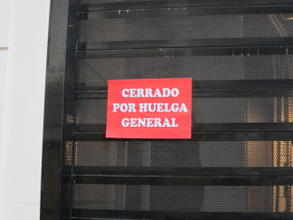 Archivo - Cartel en un comercio de Aragón cerrado por huelga general