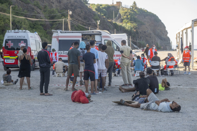 Miembros de la Cruz Roja atienden a los inmigrantes en una playa, a 21 de agosto de 2026, en Ceuta (España). Ceuta sigue afrontando una grave crisis humanitaria después de la histórica entrada masiva de más de 70.000 migrantes a nado por el Tarajal durant